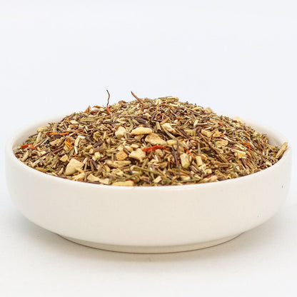 Orange Sugarbird herbal tea by Birdsong Tea featuring vibrant orange and green rooibos leaves in a tea blend.