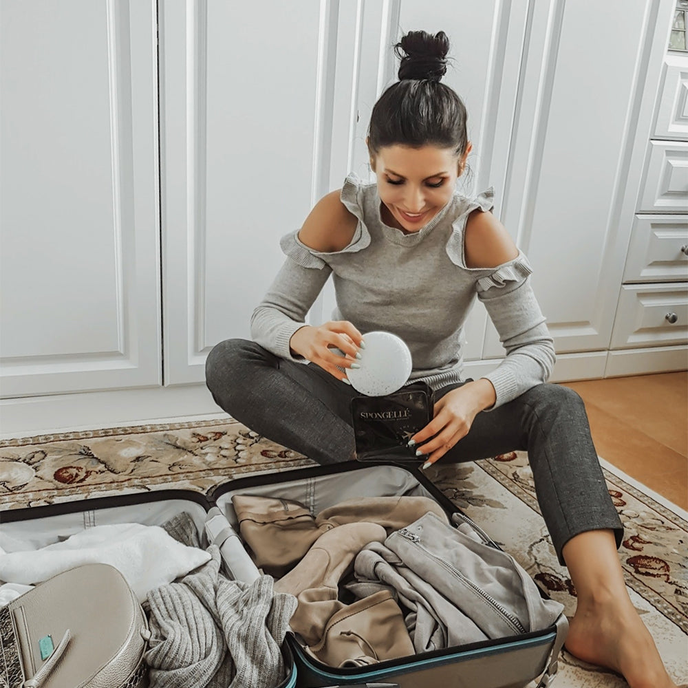 Black Spongellé travel case with zipper closure, compact and sturdy for storing toiletries or personal items on the go.