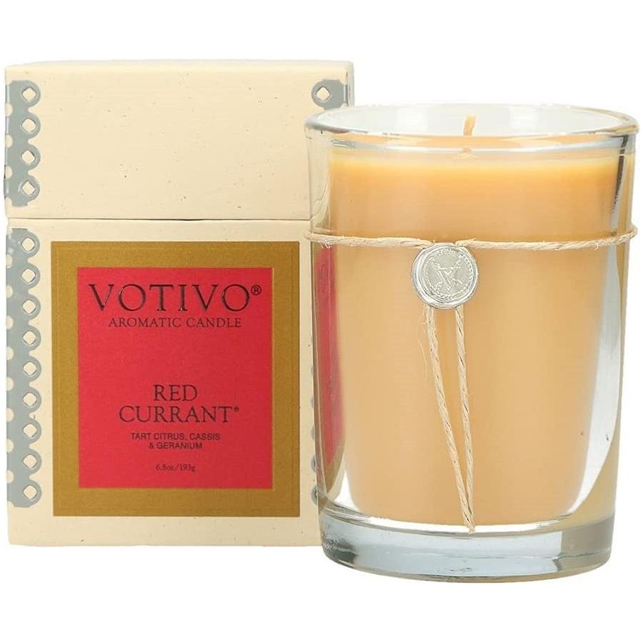 Votivo Aromatic Candle in Red Currant scent, 6.8oz, with a lit wick and red-colored wax in a glass container.