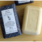 Martin de Candre single solid bar soap collection in 100g and 250g sizes, featuring benjoin scent, displayed in a natural setting.
