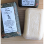 Martin de Candre solid bar soap from the collection, 100g to 250g, with benjoin scent, displayed in a natural setting.