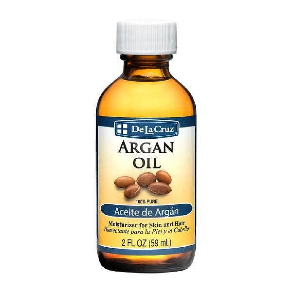 De La Cruz pure cold-pressed argan oil in a 2 fl oz bottle, used for nourishing bath and body skincare.