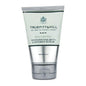 Truefitt & Hill Skin Control Invigorating Bath & Shower Scrub in 3.4 oz container, with textured scrub particles visible.