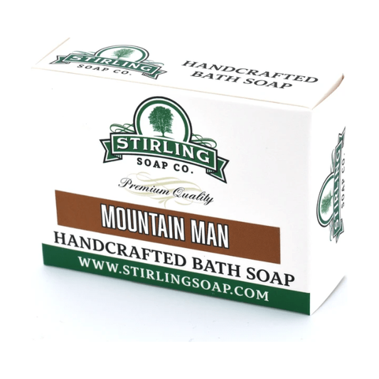 Stirling Soap Co. Mountain Man Bath Soap 5.5 oz, natural soap bar with rugged scent, in a clear wrapper, displayed on a neutral background.