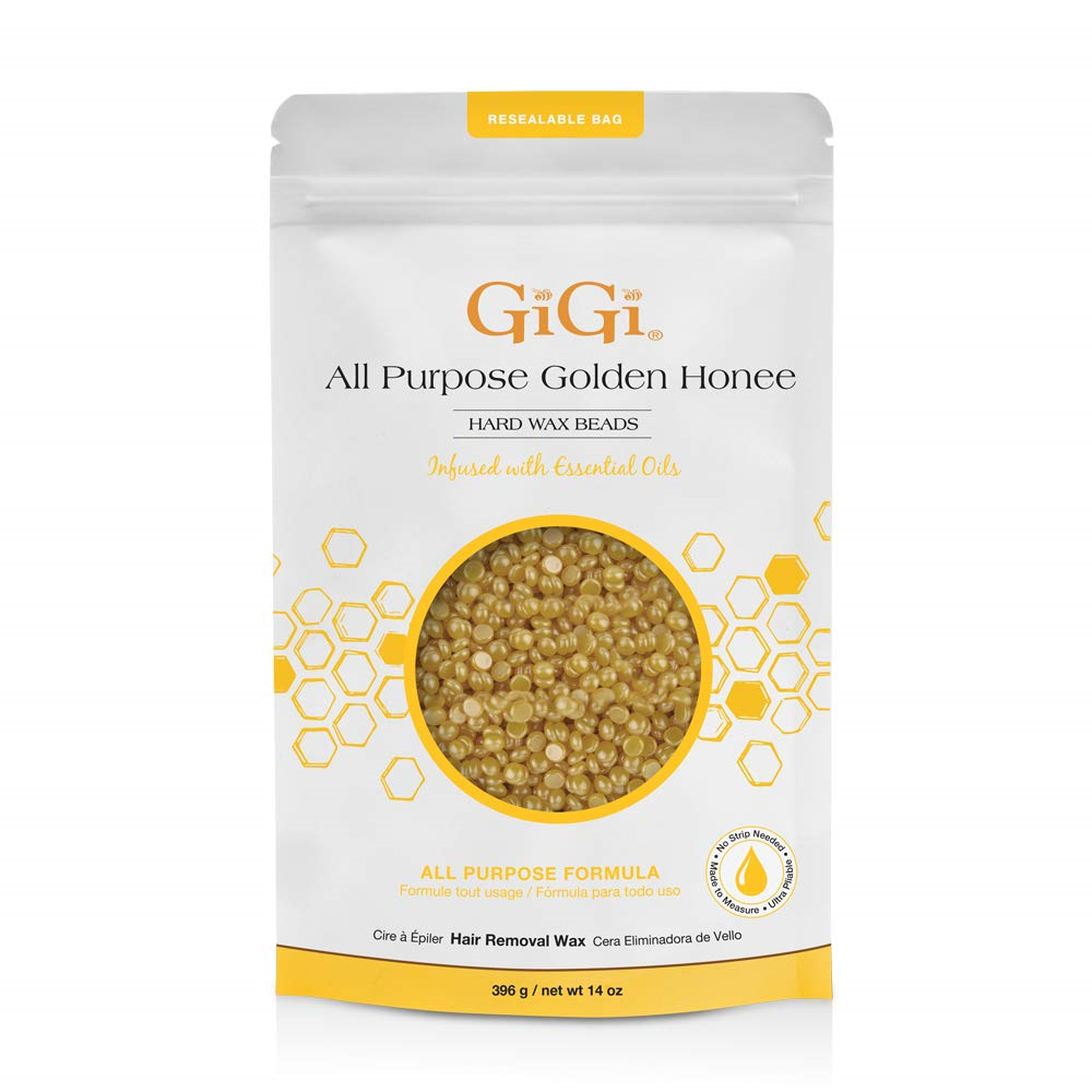 Golden hard wax beads by GiGi, 14 oz, for hair removal, shown in a clear container with golden-colored wax beads.