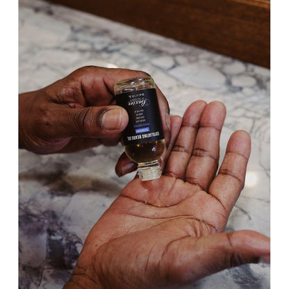 Baxter Of California exfoliating beard oil in a 1 oz bottle, natural grooming product for beard care and skin exfoliation.
