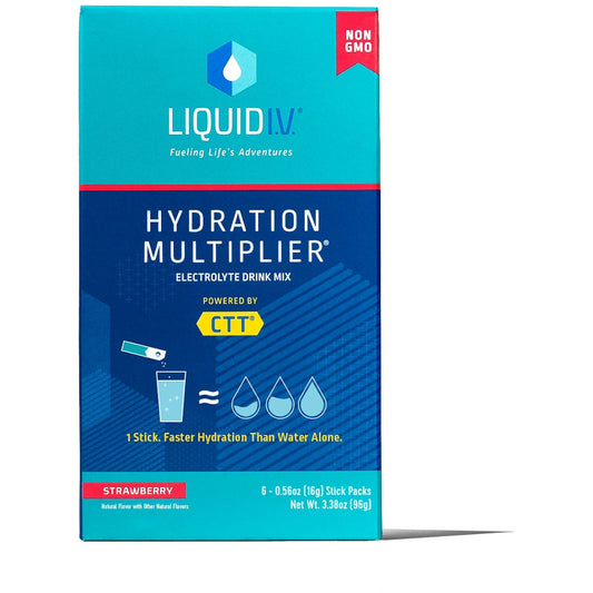Liquid I.V. Hydration Multiplier Strawberry electrolyte drink mix in a clear glass with fresh strawberries and a spoon on a white background.