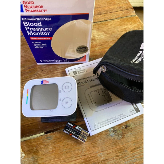 Automatic wrist blood pressure monitor from Good Neighbor Pharmacy by Pasteur Pharmacy, displaying digital readings on the device.