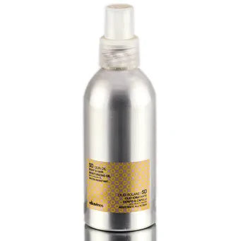 Davines Sun Oil Body & Hair Moisturizing Oil in 4.23 oz bottle, natural light reflecting off the sleek packaging.