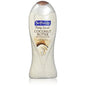 Softsoap Coconut Butter Scrub Body Wash in a clear bottle with a white cap, showing the product label and creamy texture.