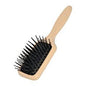 Dural paddle brush with plastic pins and beech wood handle, designed for gentle hair detangling and styling.