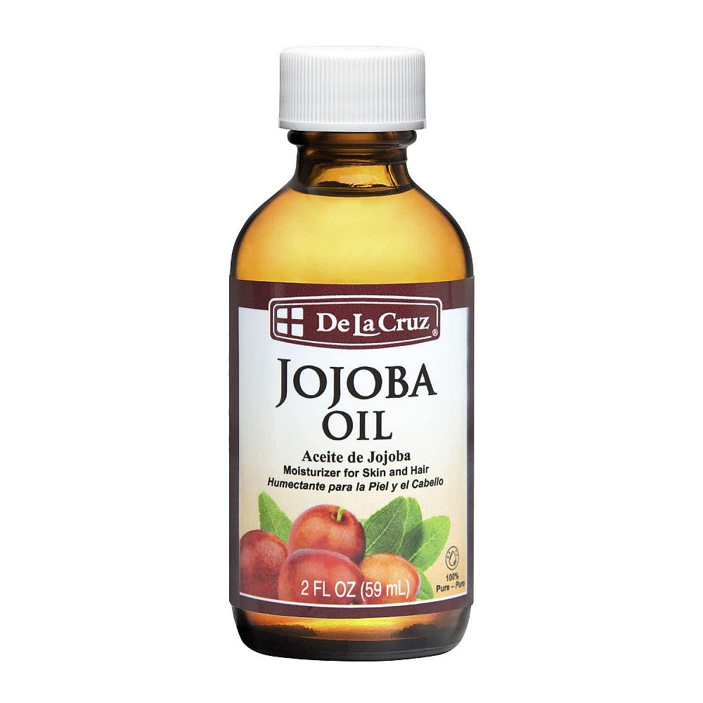 De La Cruz Jojoba Oil cold-pressed in a 2 fl oz bottle, used as cuticle cream and nourishing skin oil.
