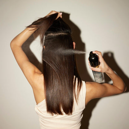 Oribe Gold Lust Dry Shampoo in 300ml bottle, featuring a sleek design and white spray nozzle for fresh, clean hair.