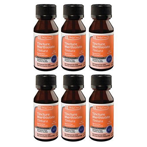 De La Cruz First Aid Antiseptic Tincture in a small glass bottle with a dropper cap, used for disinfecting minor cuts and wounds.