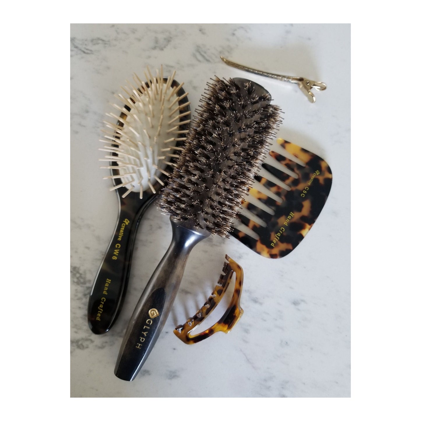 Hand-crafted Italian paddle hair brush by Pasteur Pharmacy with wooden handle and wide brushing surface.