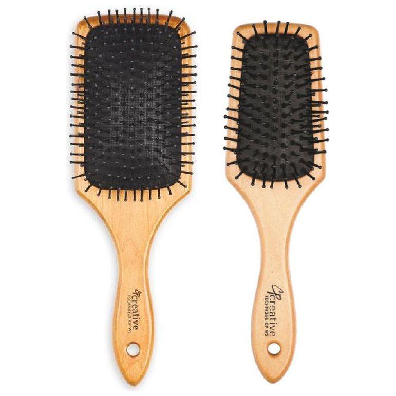 Eco-friendly wood paddle hair brush by Pasteur Pharmacy with nylon bristles, designed for gentle detangling and scalp comfort.
