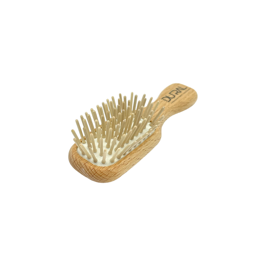 Dural beech wood mini hair brush with rubber cushion and wooden pins, ideal for gentle styling and detangling.