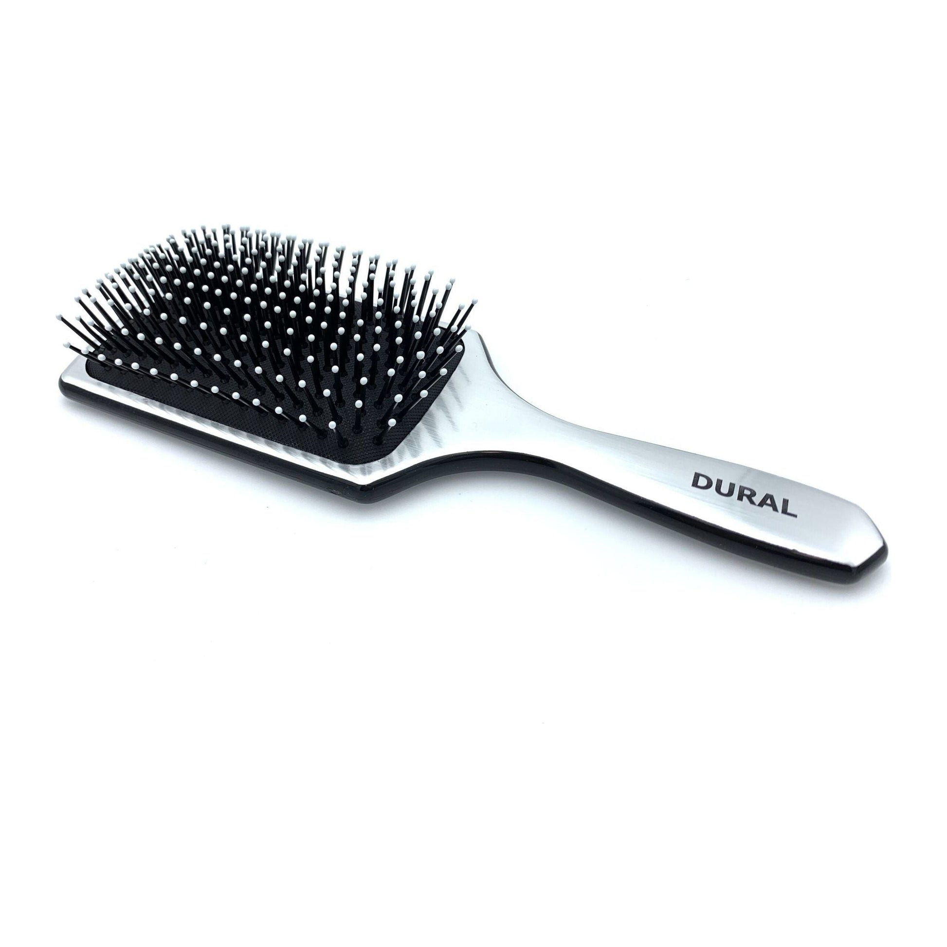 Dural paddle hair brush with plastic pins for styling and hair care, by Pasteur Pharmacy, shown with wide surface and ergonomic handle.