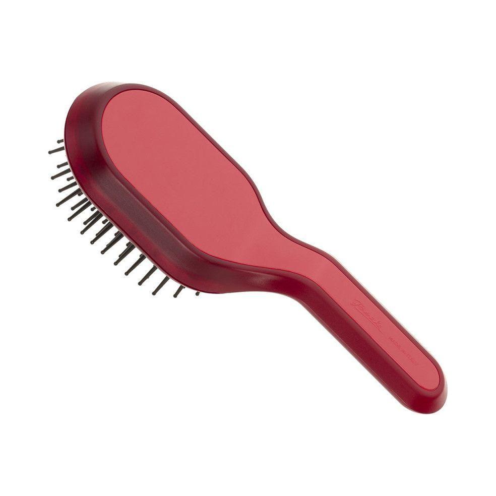 Janeke Curvy Bag Vented Hair Brush in Berry Magenta, by Pasteur Pharmacy, with a compact, ergonomic design for easy styling.