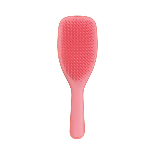 Salmon pink Tangle Teezer large detangling hairbrush with ergonomic handle for smooth, tangle-free hair.