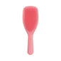 Salmon pink Tangle Teezer large detangling hairbrush with ergonomic handle for smooth, tangle-free hair.