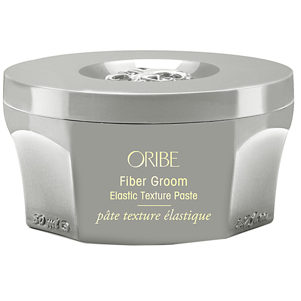 Oribe Fiber Groom Elastic Texture Paste in a jar, showcasing the hair care product with a sleek design and branding.