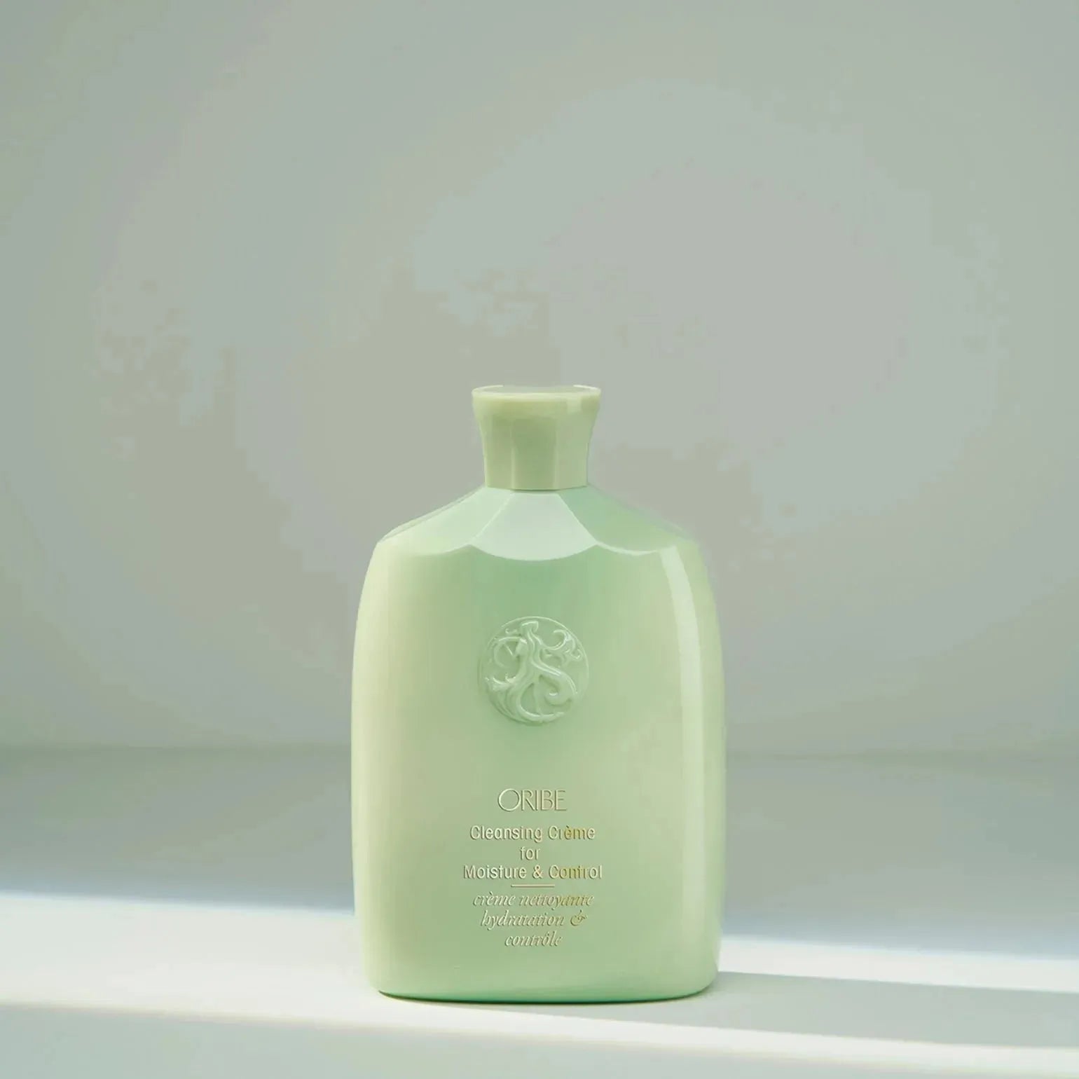 Oribe Cleansing Crème for Moisture & Control, 250ml, a hair care product designed to hydrate and manage hair effectively.