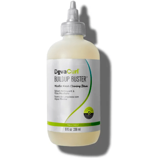 DevaCurl Buildup Buster Micellar Water Cleansing Serum for hair, 8 oz, in a transparent bottle with a pump dispenser.