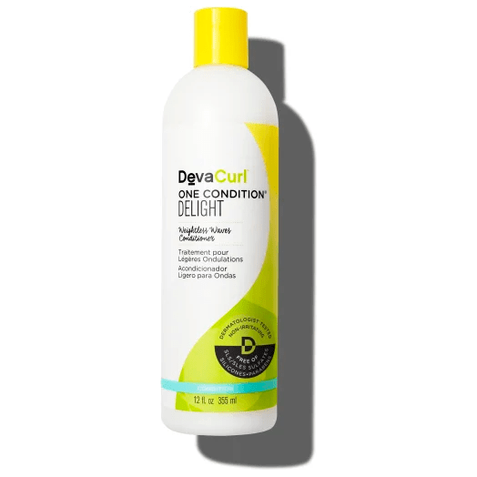 DevaCurl One Condition Delight 12 oz hair conditioner in a white bottle with a pump dispenser, designed for curly hair care.