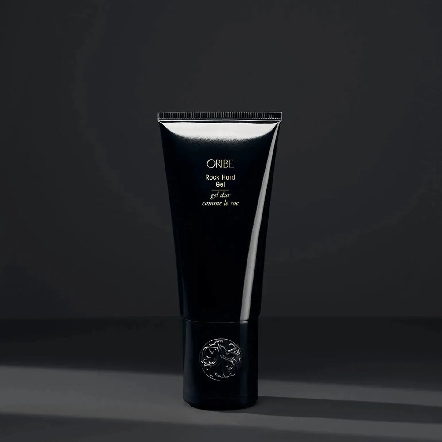 Oribe Rock Hard Gel 100ml hair gel in a clear jar with a black lid, designed for strong hold and styling control.