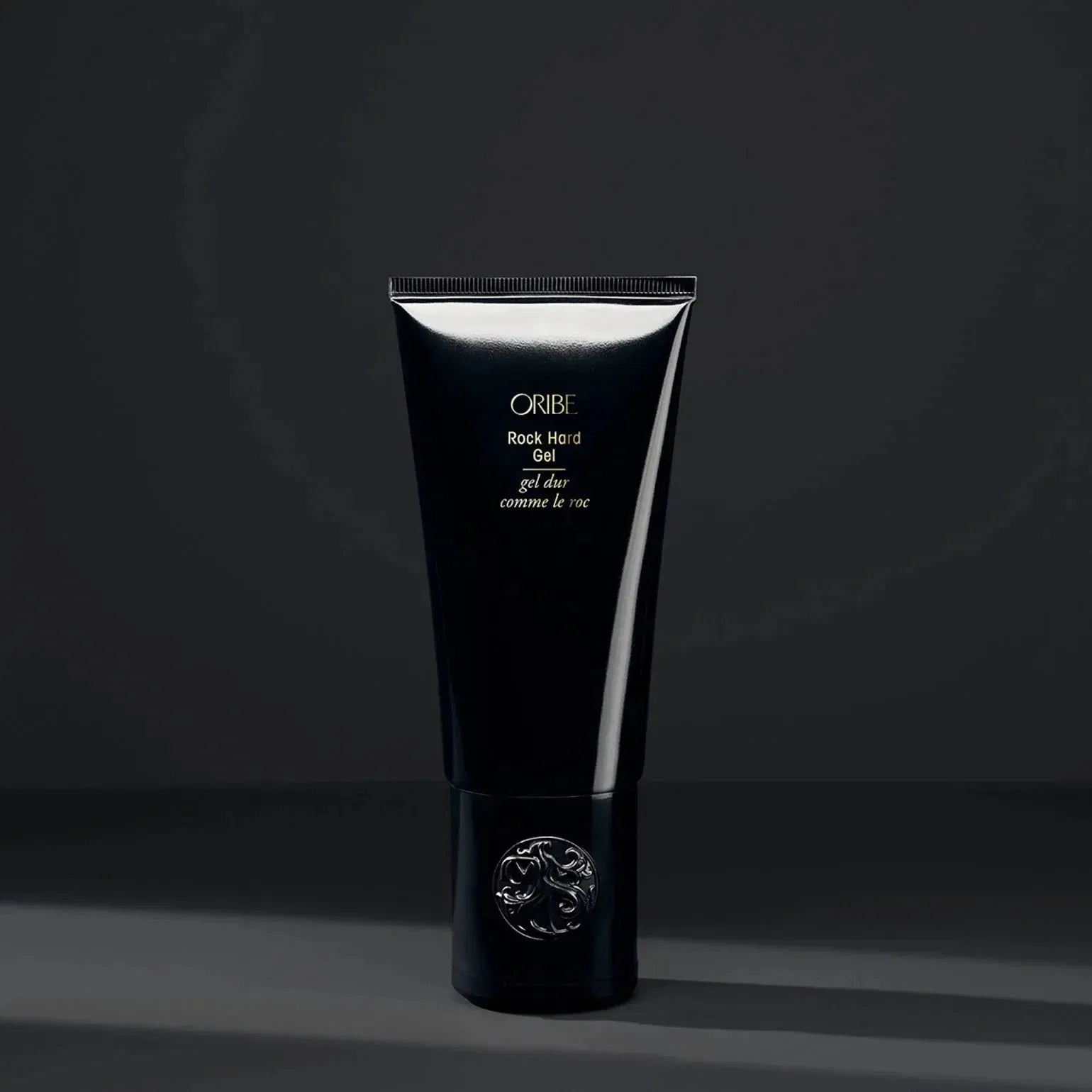 Oribe Rock Hard Gel 100ml hair gel in a clear jar with a black lid, designed for strong hold and styling control.