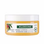 Klorane Masque Nutrition 5oz hair masque with nourishing ingredients, shown in a white container on a bathroom counter.