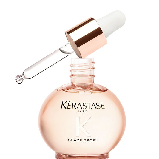 Kerastase Gloss Absolu Wild Rose Hair Serum drops in a clear bottle with dropper, designed for shiny, smooth hair.