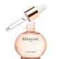 Kerastase Gloss Absolu Wild Rose Hair Serum drops in a clear bottle with dropper, designed for shiny, smooth hair.