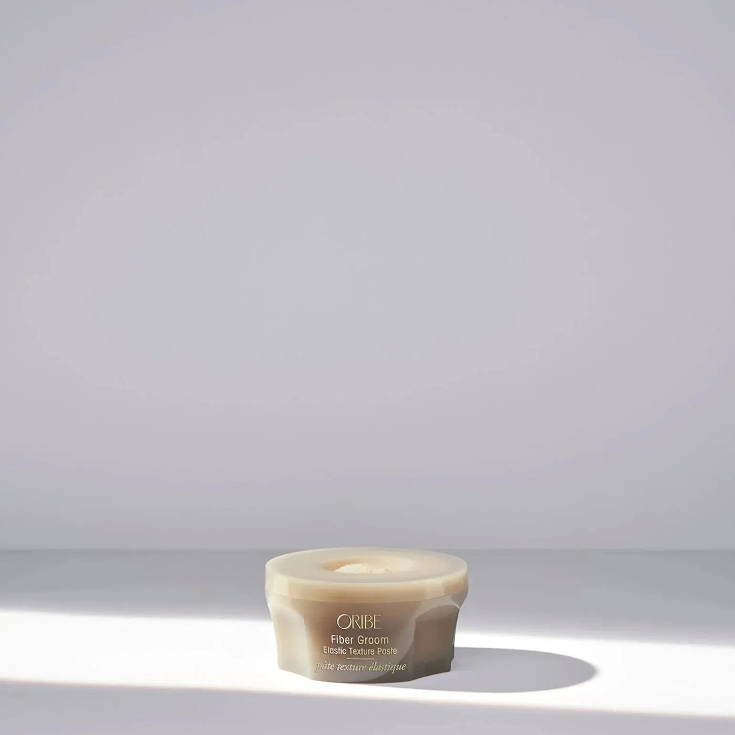 Oribe Fiber Groom Elastic Texture Paste 50ml hair styling paste with flexible hold and natural finish, shown in a sleek container.