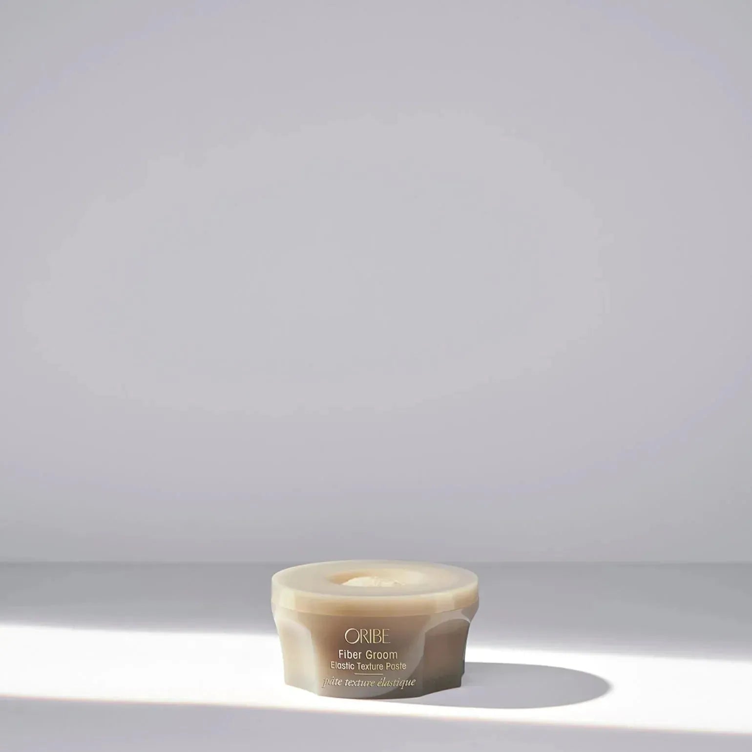 Oribe Fiber Groom Elastic Texture Paste 50ml hair styling paste with flexible hold and natural finish, shown in a sleek container.