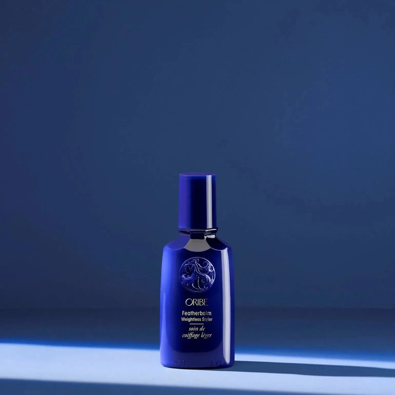 Oribe Featherbalm Weightless Styler 100ml hair styling product for lightweight, manageable hair, shown in a sleek bottle.