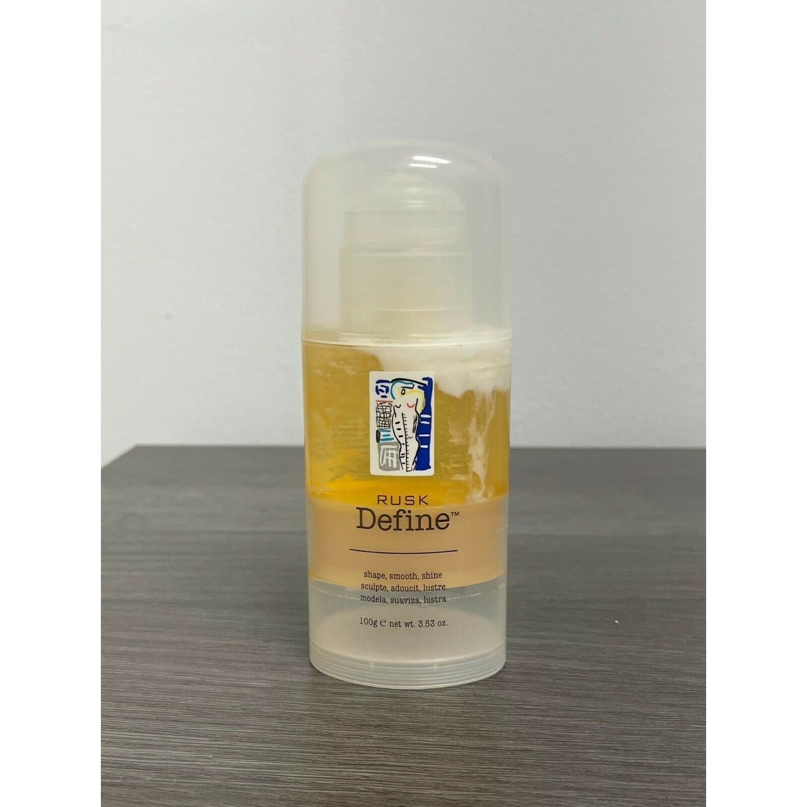 Rusk Define Shape Smooth Shine hair styling product in 3.53 oz bottle, ideal for shaping and adding shine to hair.