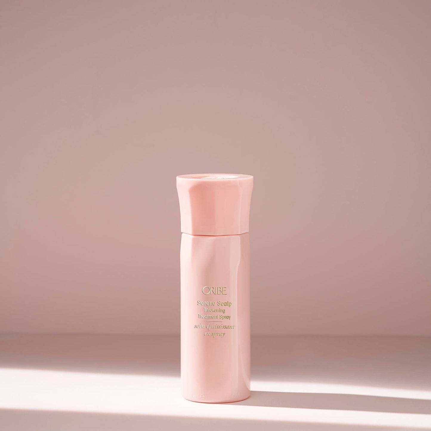 Oribe Serene Scalp Thickening Treatment Spray in 125 ml bottle, a hair treatment spray for scalp and hair volume enhancement.