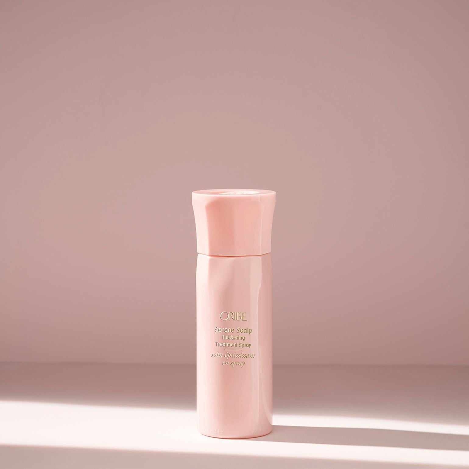 Oribe Serene Scalp Thickening Treatment Spray in 125 ml bottle, a hair treatment spray for scalp and hair volume enhancement.