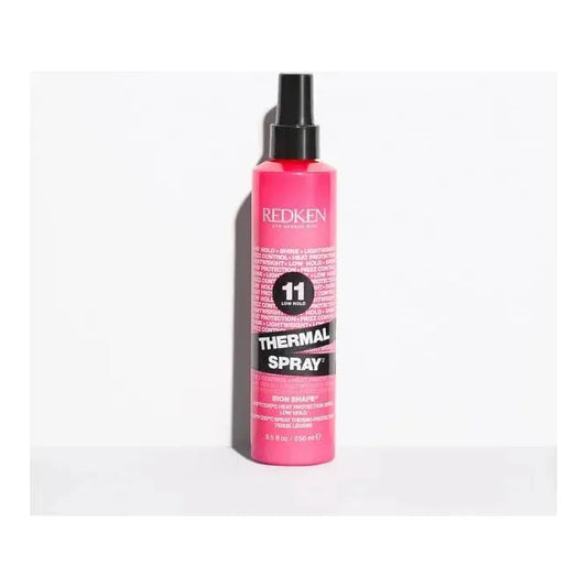 Redken Iron Shape 11 finishing thermal hairspray bottle, 8.5 oz, with a red and silver design and spray nozzle.