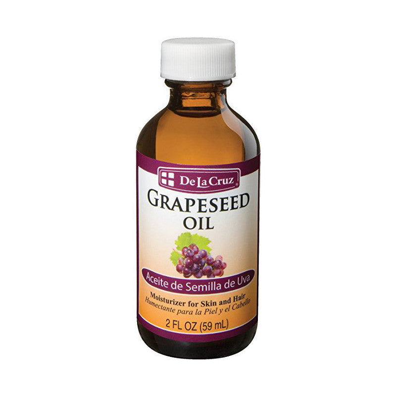 De La Cruz Grapeseed Oil in a 2 Fl Oz bottle, natural health and beauty product with clear label, used for skincare or massage.