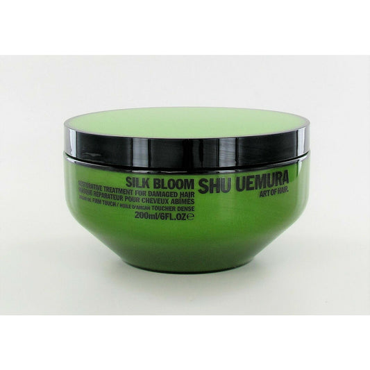 Shu Uemura Silk Bloom Restorative Treatment for hair, in a sleek bottle, designed to nourish and restore hair health.