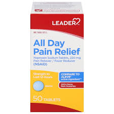 Leader All Day Pain Relief Naproxen Sodium 220 mg caplets, used for pain relief, shown in a bottle on a healthcare product display.