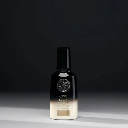 Oribe Balm d'Or Heat Styling Shield 100ml bottle, protective spray for heat styling, with sleek design and pump nozzle.