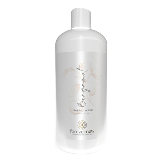 Forever New Bergamot Fabric Wash laundry detergent bottle by Pasteur Pharmacy, 16 oz, with a focus on the product label and packaging