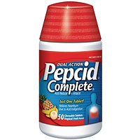 Pepcid Complete acid reducer and antacid chewable tablets in tropical fruit flavor, shown in blister packaging.