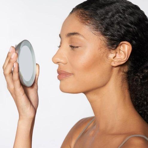 Tweezerman LED 15X mini mirror showing a compact, portable mirror with built-in LED light for detailed reflection.