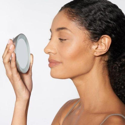 Tweezerman LED 15X mini mirror showing a compact, portable mirror with built-in LED light for detailed reflection.