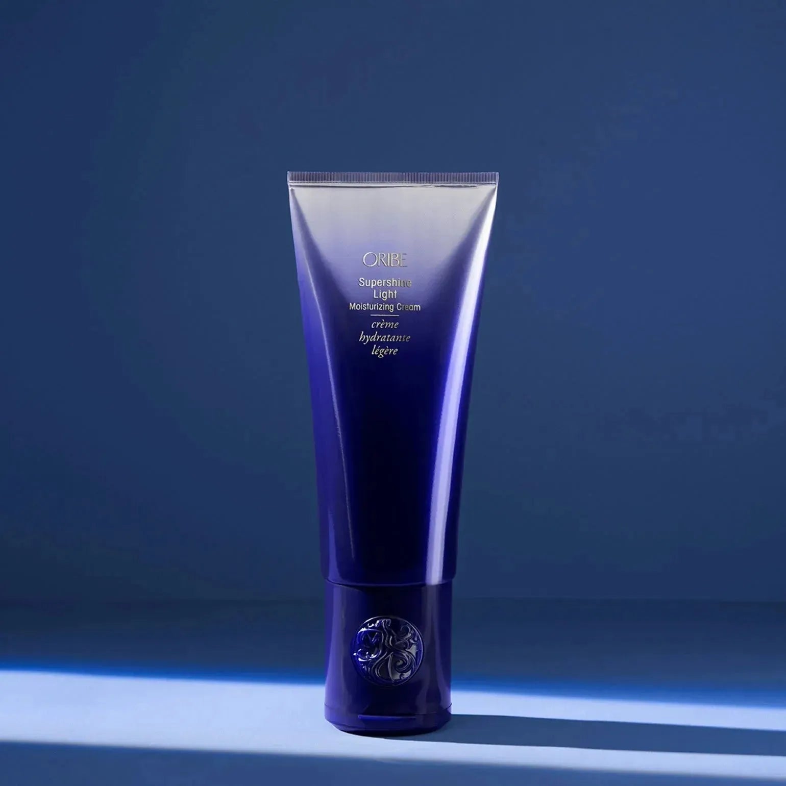Oribe Supershine Light Moisturizing Cream in a 150ml jar, smooth and lightweight formula for shiny, hydrated hair.